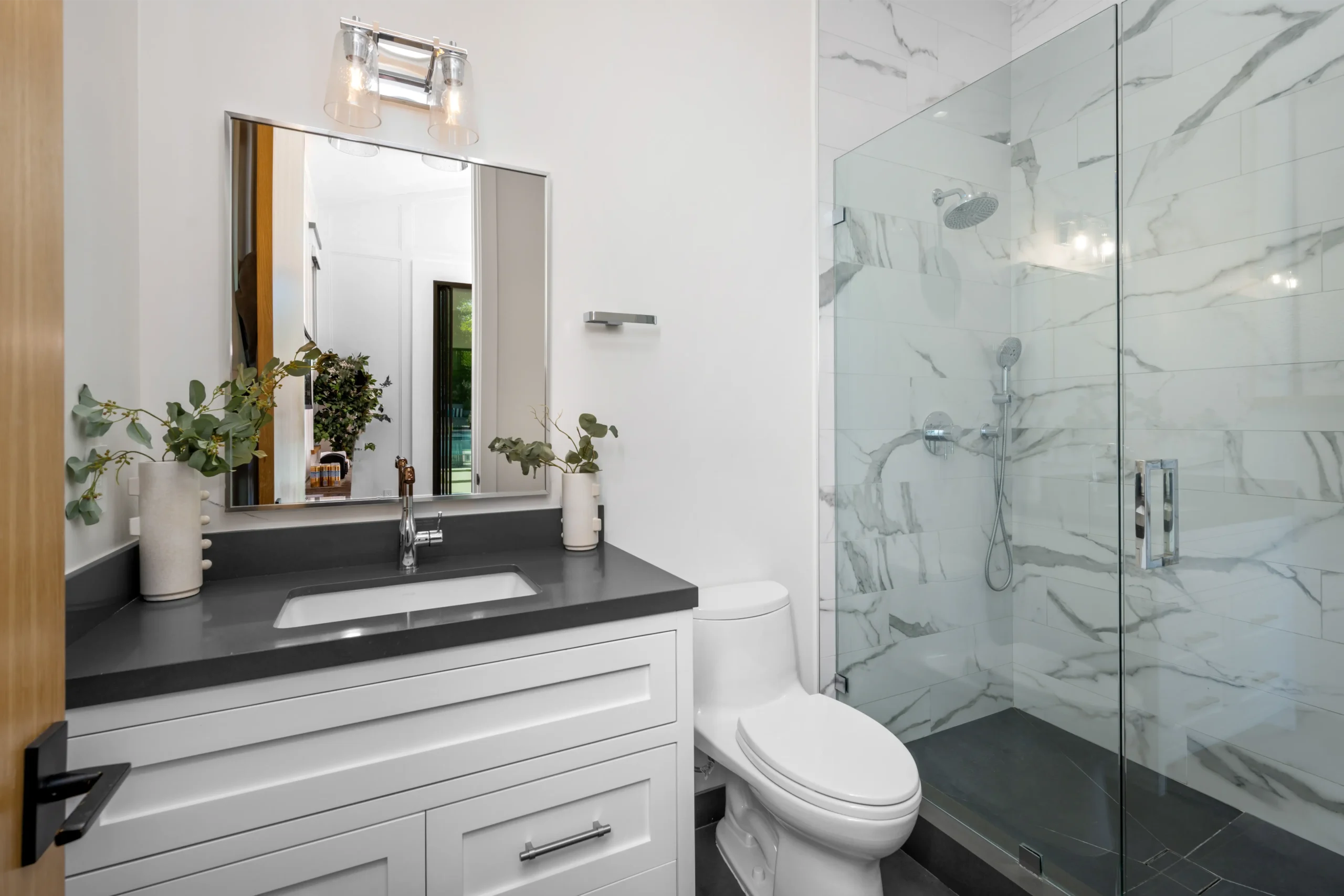 a-white-toilet-sitting-next-to-a-walk-in-shower-ne-2025-02-11-19-45-57-utc